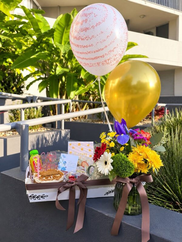 Celebration Tray with Flowers: tray with colourful fresh flowers and gold and marbled balloons